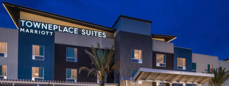 A render of the Merced Towneplace Suites during the night.