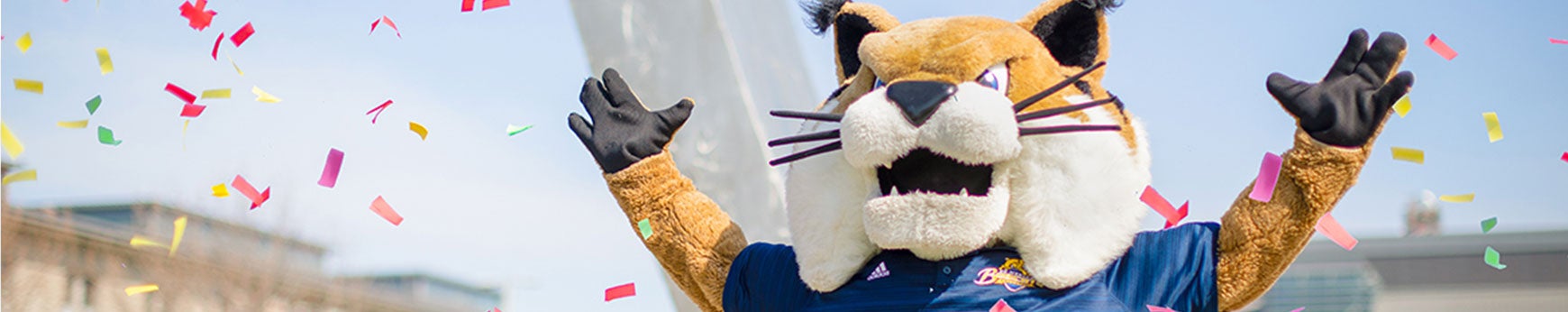 uc merced mascot Rufus the Bobcat celebrating and throwing confetti