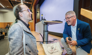 UC Tech Keynote Speaker, Dr. Joshua Viers, speaking directly to an attendee.