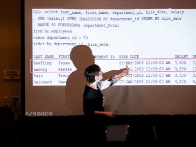 UC Tech 2025 speaker presenting for their session, pointing at their slide..